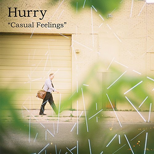 Album cover: man walking past a yellow building with abstract lines.