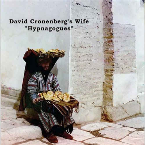 CD cover: person in striped robe with bread, next to a wall.