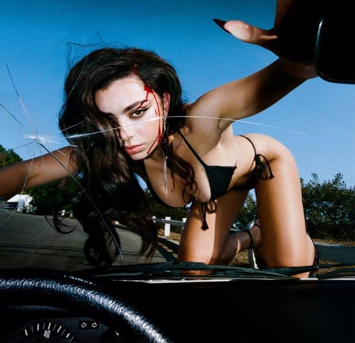 Charli XCX album cover featuring a woman amidst shattered car glass.
