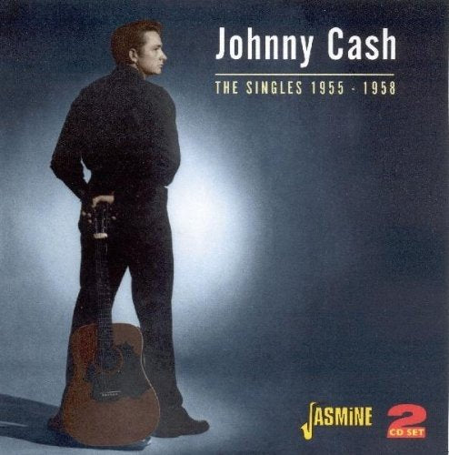 Johnny Cash CD cover featuring a man with a guitar, dark background, and spotlight.