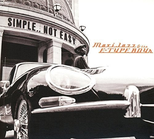 "Black and white album cover with a man standing beside a vintage car."