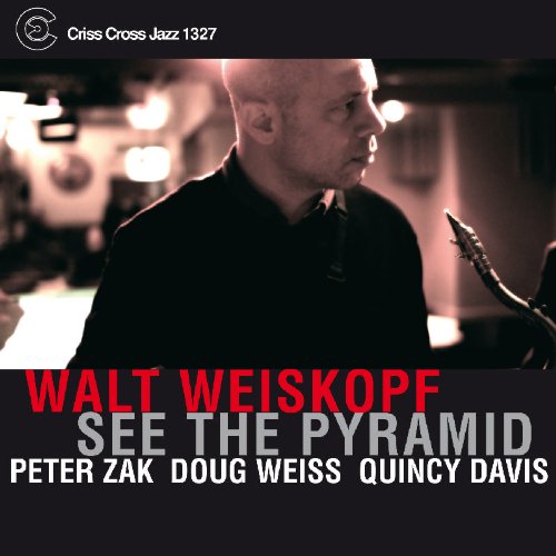 "Album cover with a man holding a saxophone, featuring red and gray text."
