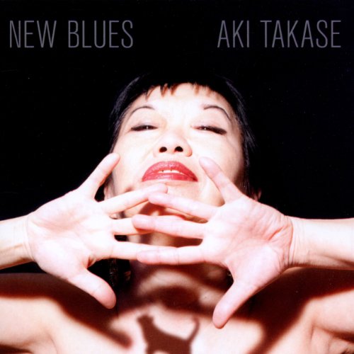Aki Takase album cover: close-up of a woman with hands framing her face.