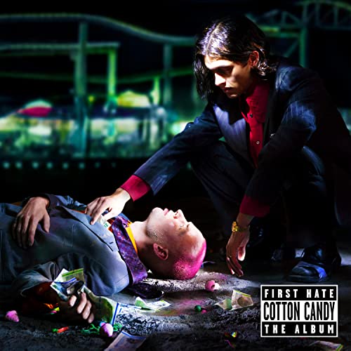 Two figures in suits, one kneeling beside a person lying down.