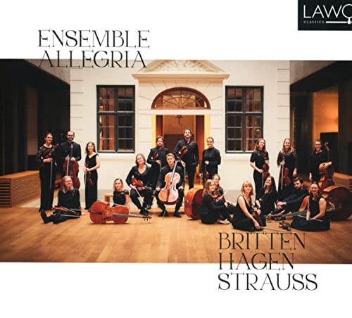 Classical music ensemble posing with instruments in a grand, arched hallway.
