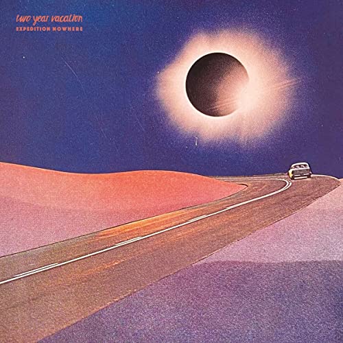 Vinyl record cover: desert road leading to a solar eclipse.