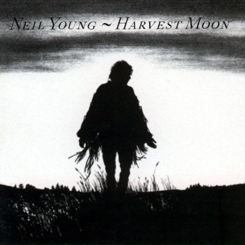 "Album cover featuring a black-and-white silhouette of a man holding grain stalks."