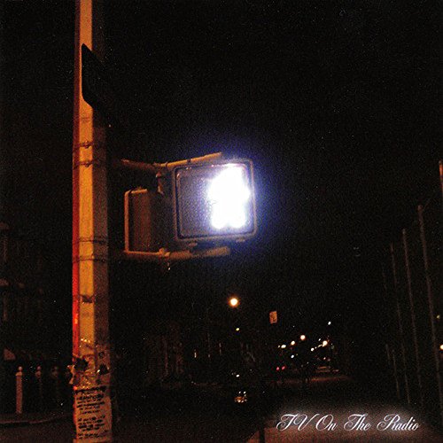 Dark album cover featuring a glowing traffic signal at night.