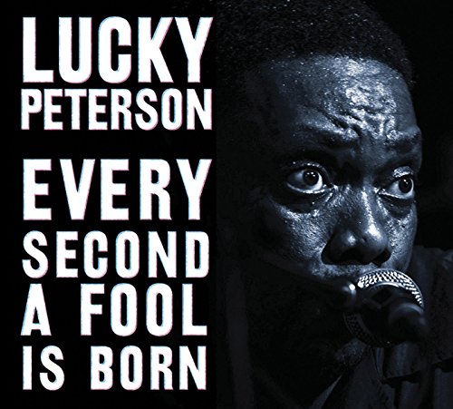 Album cover: black background, close-up of man singing into a microphone, white text.