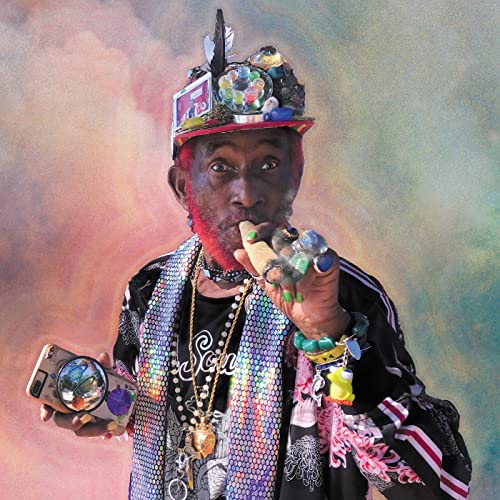 Lee “Scratch” Perry portrait with elaborate headwear and jewelry.