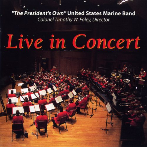 US Marine Band performing live in concert on a stage.