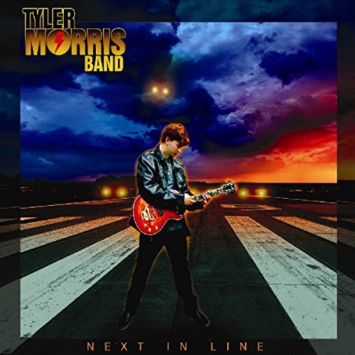 "Album cover with a man playing red guitar on a runway at sunset."