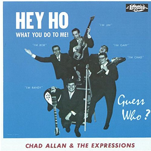 "Blue album cover with five men in suits playing instruments, titled 'Hey Ho'."