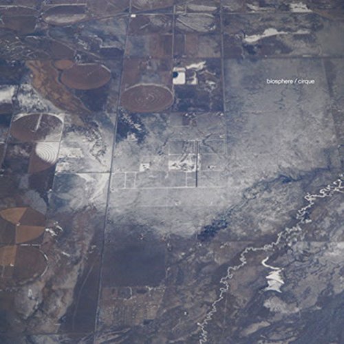 Aerial view of circular farmland with album title overlayed.