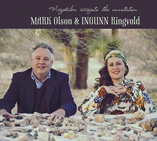 "CD cover featuring a man and woman surrounded by rocks in a desert landscape."