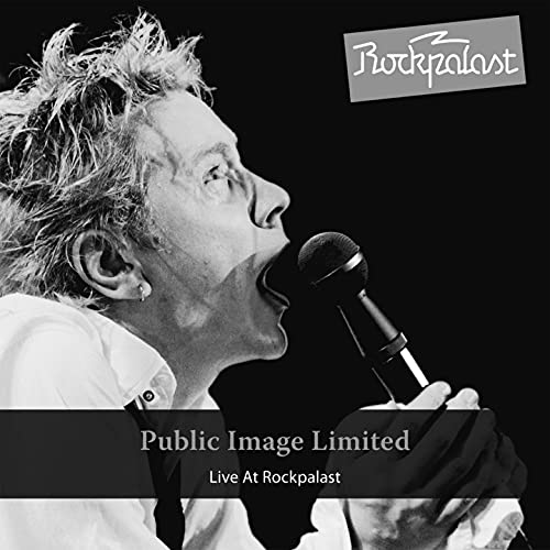Black and white image of John Lydon singing into a microphone.