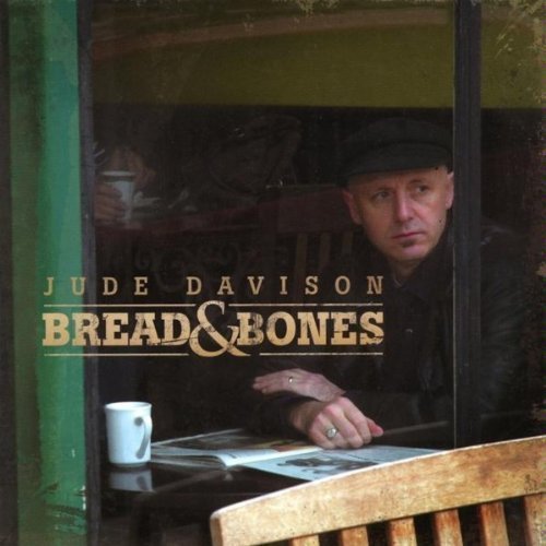 "Album cover featuring a man sitting at a table with a coffee cup."