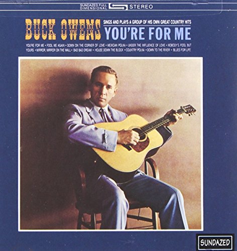 "Album cover with Buck Owens holding a guitar, seated on a chair, against a brown background."