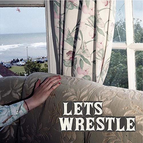CD cover with hand on sofa, view of sea and floral curtains.