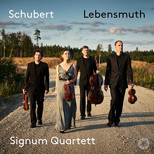 String quartet Signum Quartett walking on a rural dirt road.