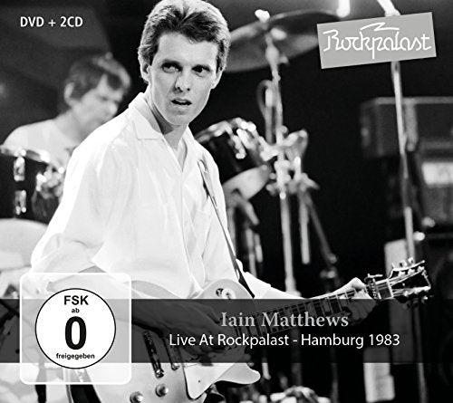 Black and white image of Iain Matthews playing guitar onstage, 1983.