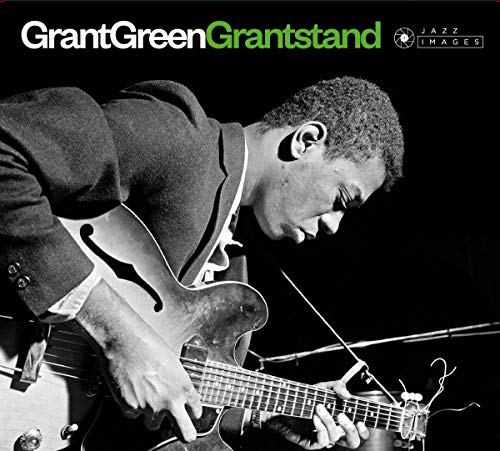 Black and white photo of Grant Green playing a hollow-body electric guitar.