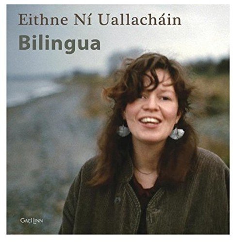 "CD cover featuring a smiling woman with long brown hair on a beach."