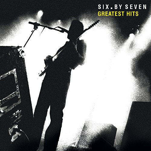 "Album cover featuring a black-and-white silhouette of a guitarist on stage with bright lights."