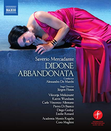 Woman in pink dress lying on stone, head down, on opera recording cover.