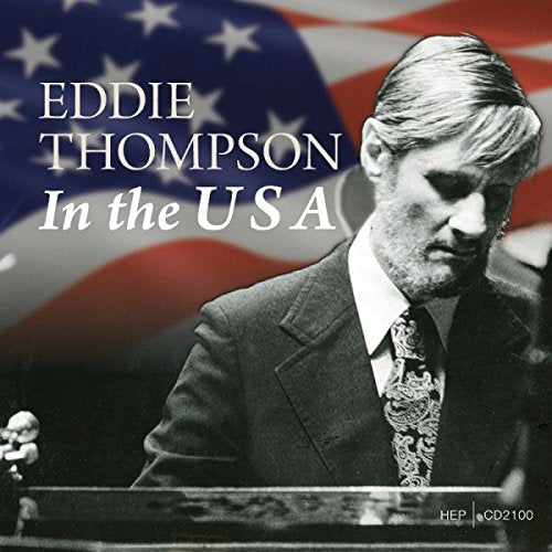 "Album cover featuring a man at a piano with an American flag background."
