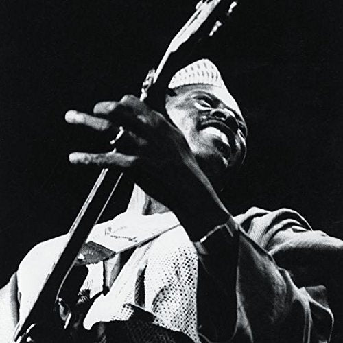 Black and white image of a man playing a guitar.