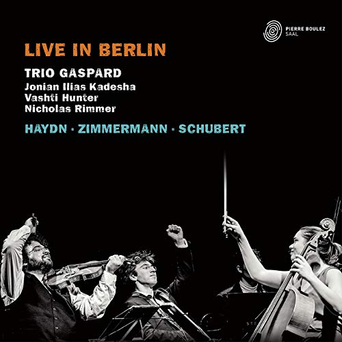 "CD cover with three musicians playing instruments, black background, text 'Live in Berlin'."