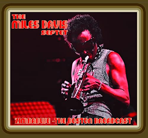 Miles Davis playing trumpet on album cover, red and black tones.