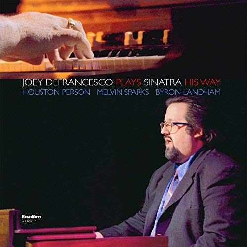 Vinyl album cover featuring a man playing the organ with a hand close-up.