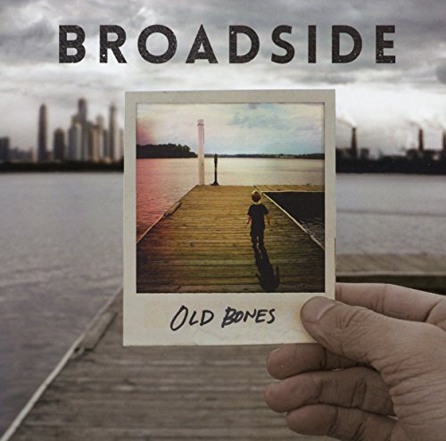 The alt text for the image is: "Album cover with Polaroid photo of child on a dock."