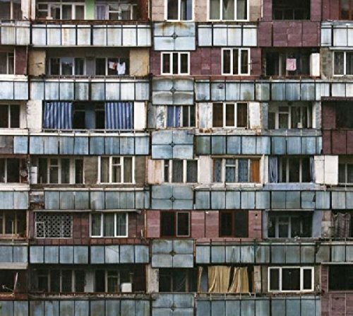 CD cover featuring a densely packed facade of weathered apartment buildings.