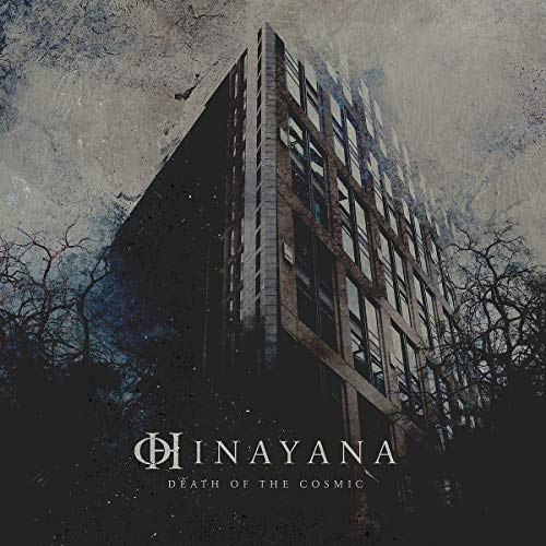 "Album cover featuring a dark, multi-story building with bare trees and cloudy sky."