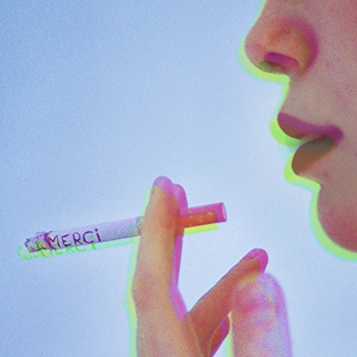 A person smokes a cigarette with "MERCI" written on it, against a light background.