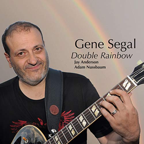"Album cover featuring Gene Segal holding a guitar with a rainbow in the background."