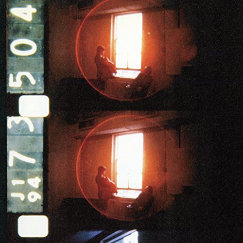 "CD cover with double exposure image of a man and woman by a window."