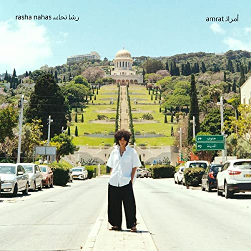 CD cover: woman on a road with a building and landscape backdrop.