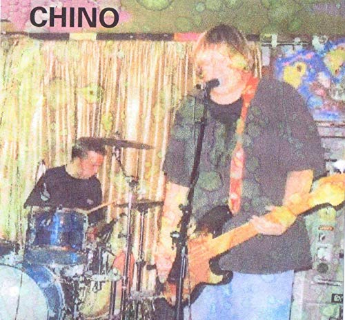 CD cover featuring a band performing live, with a guitarist in focus.