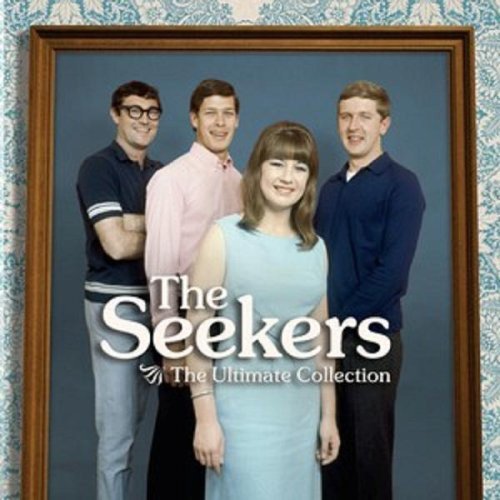 The image shows a framed album cover featuring four people. Alt text: Framed album cover with four people, three men and one woman.