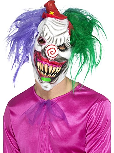 A person wearing a white clown mask, pink shirt, and colourful wig.