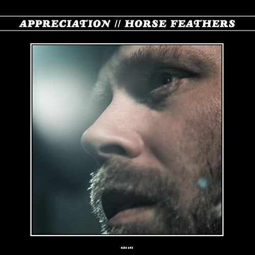 "Album cover with a man's face, mouth open, against a black background."