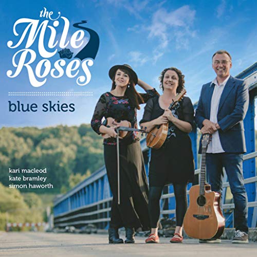 "Album cover featuring three musicians standing on a bridge with guitars."
