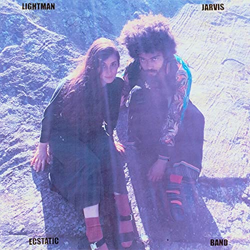 Album cover featuring two people with long hair in a rocky landscape.