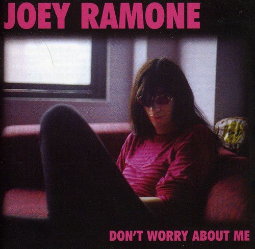 "Album cover with Joey Ramone sitting on a couch, wearing sunglasses and a pink shirt."
