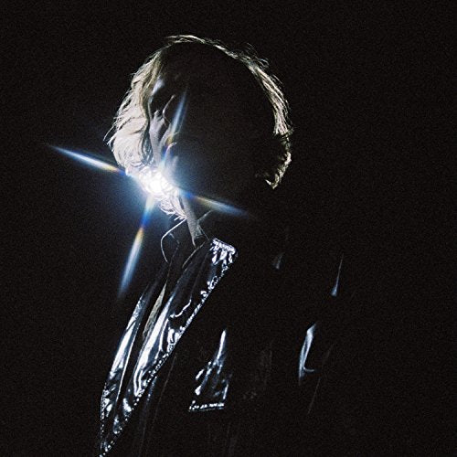 Portrait of a person with light flare obscuring their face.