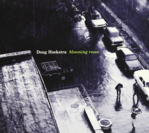 "CD album cover with black and white image of a rainy street scene."